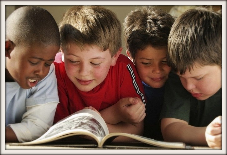 Image of Four Boys Reading a Book